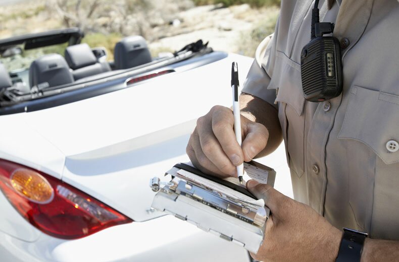 Officer writing a driver a ticket